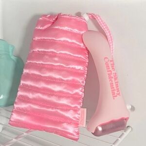 Skinny Confidential Hot Mess Ice Roller and "Sleeping Bag" storage pouch.